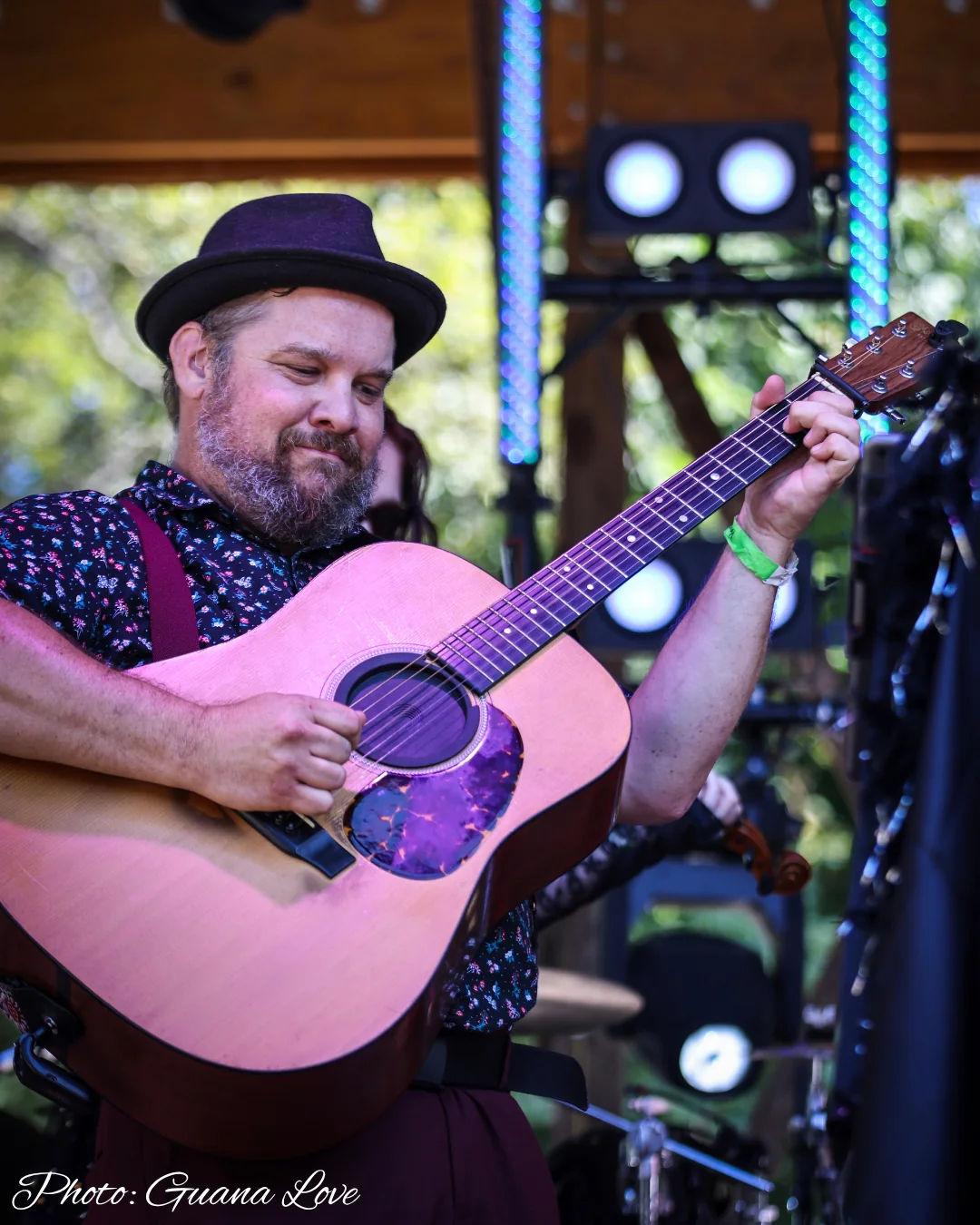 The guitarist performing on acoustic guitar