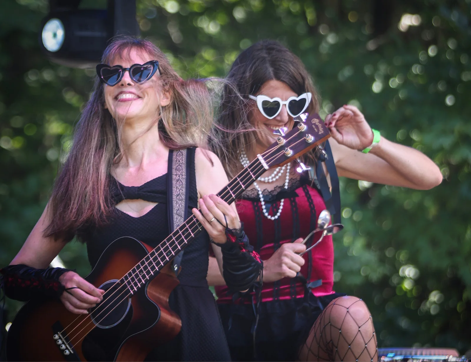 The acoustic bassist and fiddle player performing outdoors