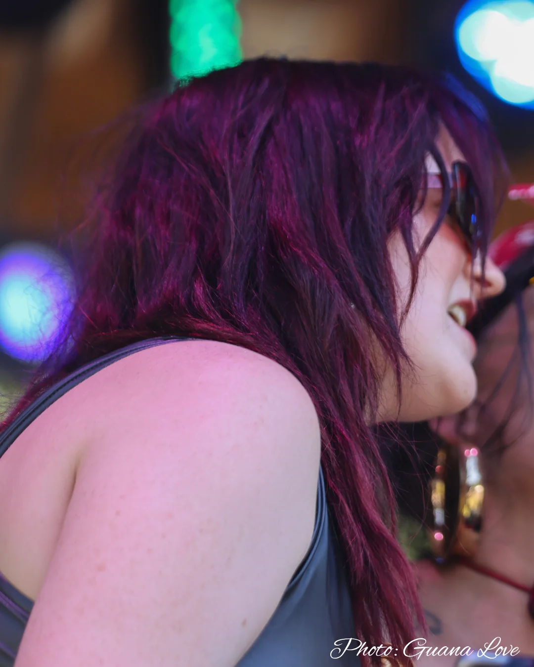 A musician in profile under warm performance lights
